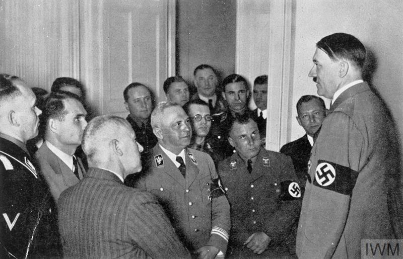 Adolf Hitler discusses with officials after the Reichstag elections